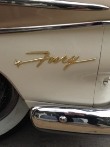 Gold Fury emblem on cream classic car