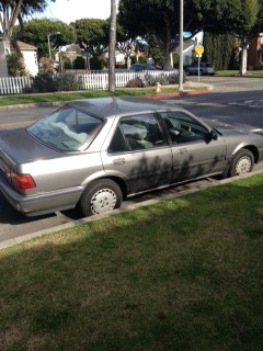 Silver sedan parked on residential street curb